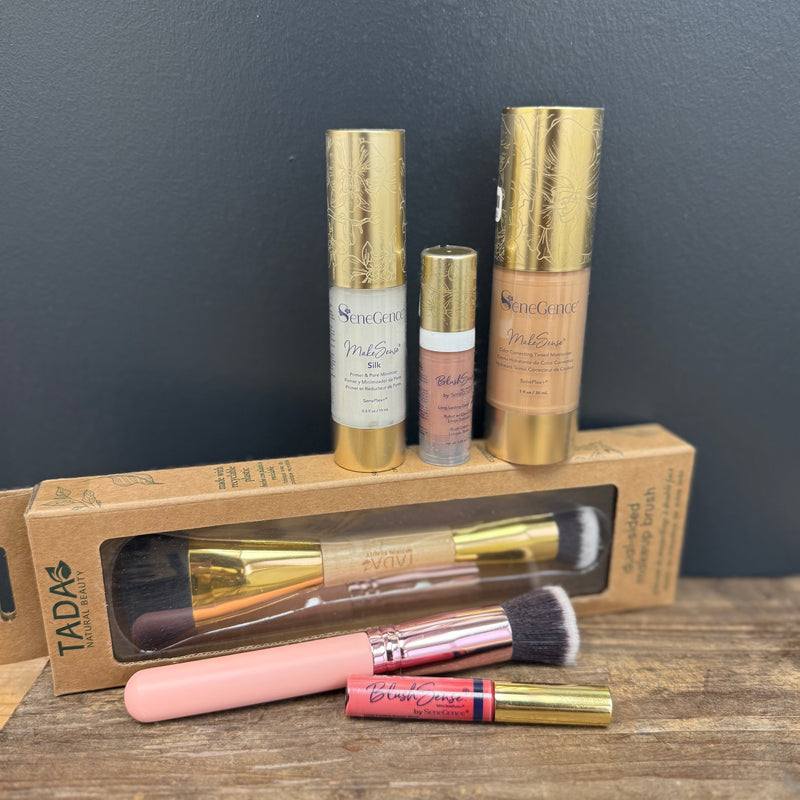 Makeup products including bottles and brushes on a wooden surface with a dark gray background