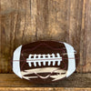 Football-shaped object on a wooden background