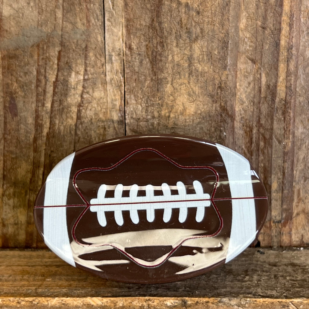Football-shaped object on a wooden background