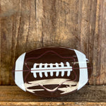 Football-shaped object on a wooden background