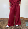 maroon outfit with wide-leg pants 
