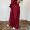 maroon outfit with wide-leg pants 