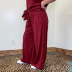 maroon outfit with wide-leg pants 