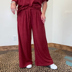 maroon outfit with wide-leg pants 