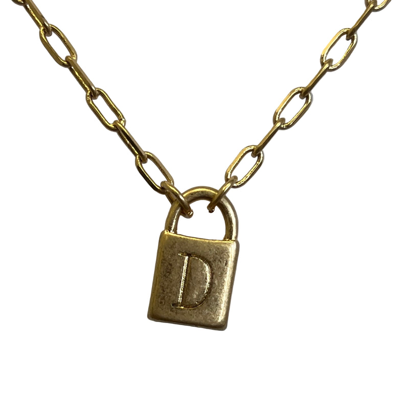 Gold necklace with a lock-shaped pendant on a light gray background