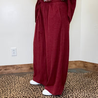 maroon outfit with wide-leg pants 