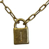 Gold necklace with a lock-shaped pendant on a white background