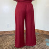 maroon outfit with wide-leg pants 