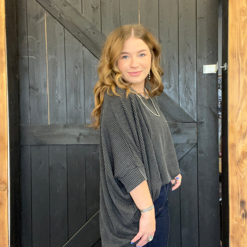 Woman standing in front of a wooden door