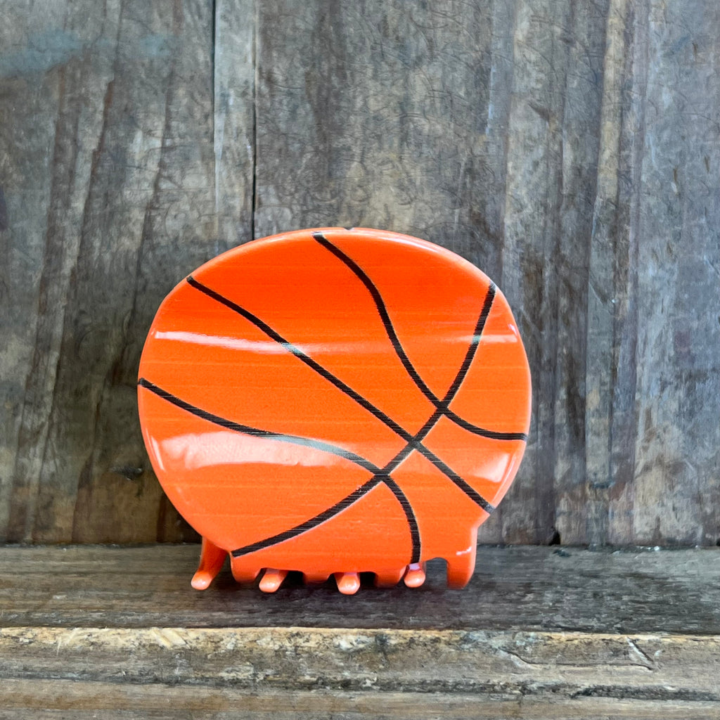Ceramic elephant with basketball design on a wooden surface