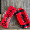 Red football-shaped container with 'GAMEDAY' text on a wooden background