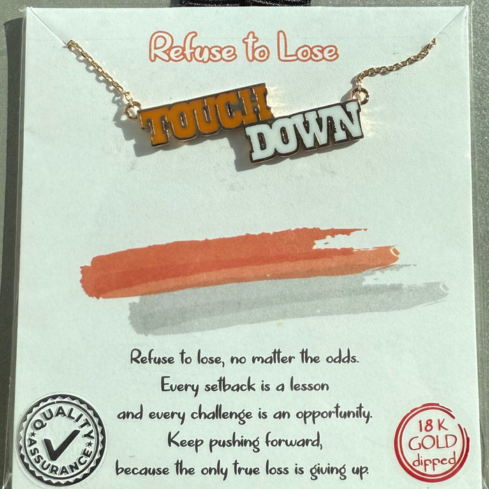 Necklace with 'Touchdown' pendant on a branded card with motivational quote.