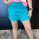 Turquoise High Waisted Athletic Shorts with Zip Waist Pocket.