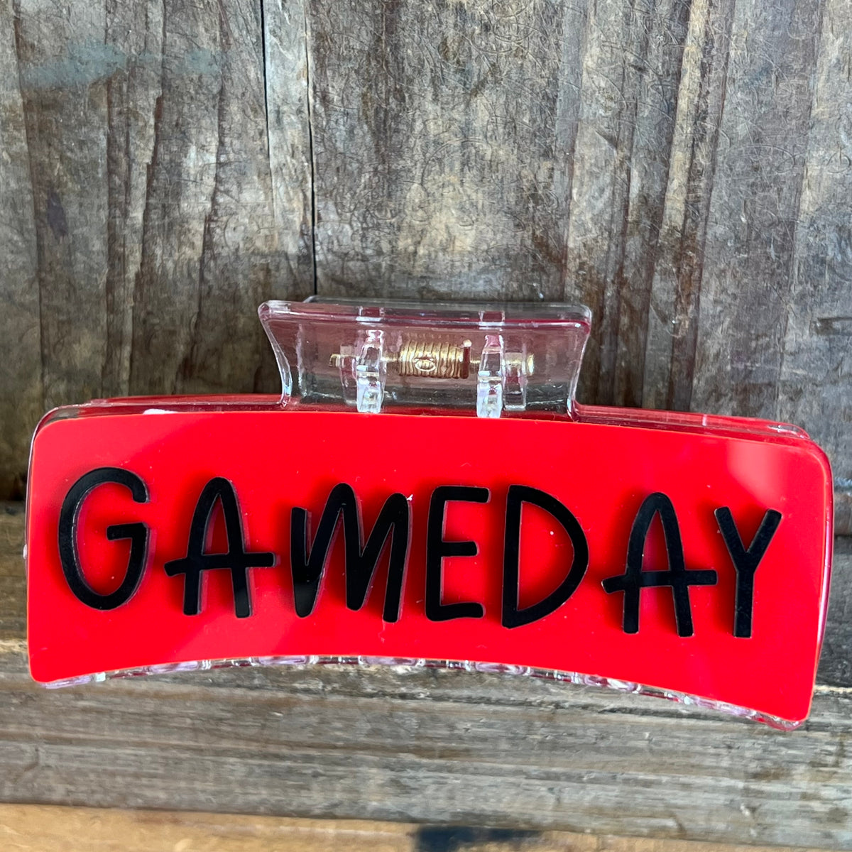 Red sign with 'GAMEDAY' text on a wooden surface