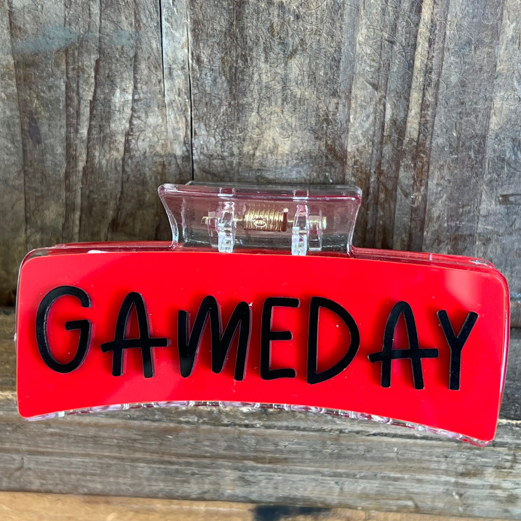 Red sign with 'GAMEDAY' text on a wooden surface