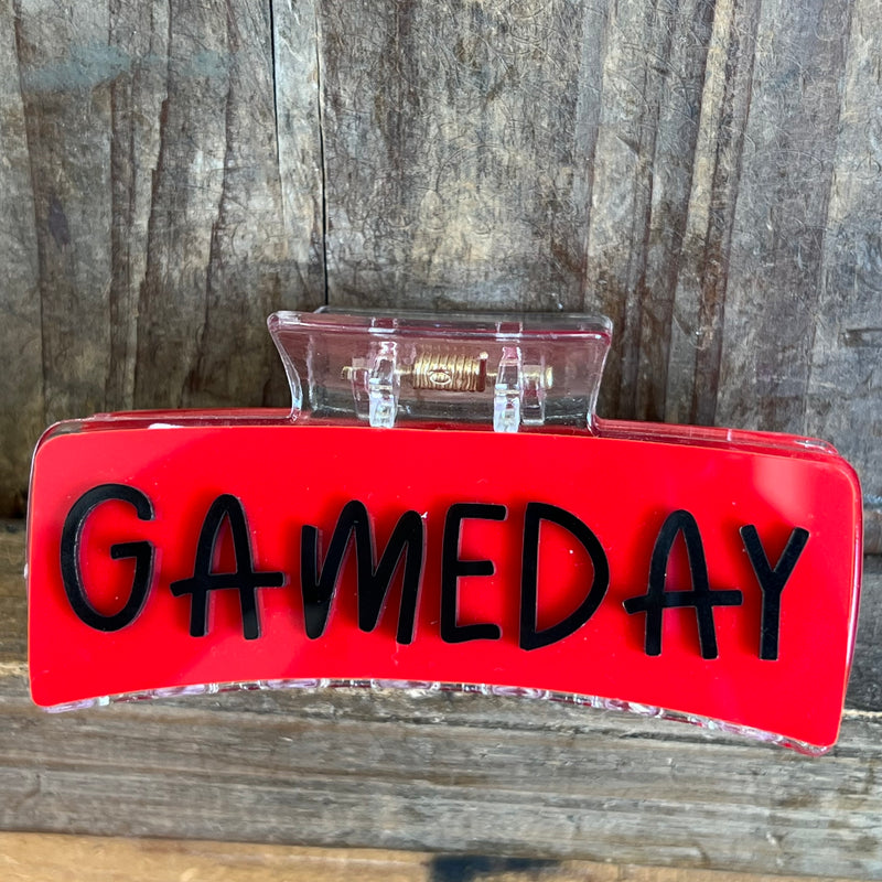 Red sign with 'GAMEDAY' text on a wooden surface