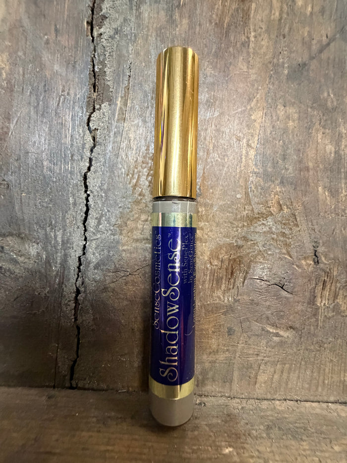 Gold and blue cylindrical object on a wooden surface