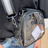 Clear pouch with a visible brand label attached to a person wearing a black jacket.