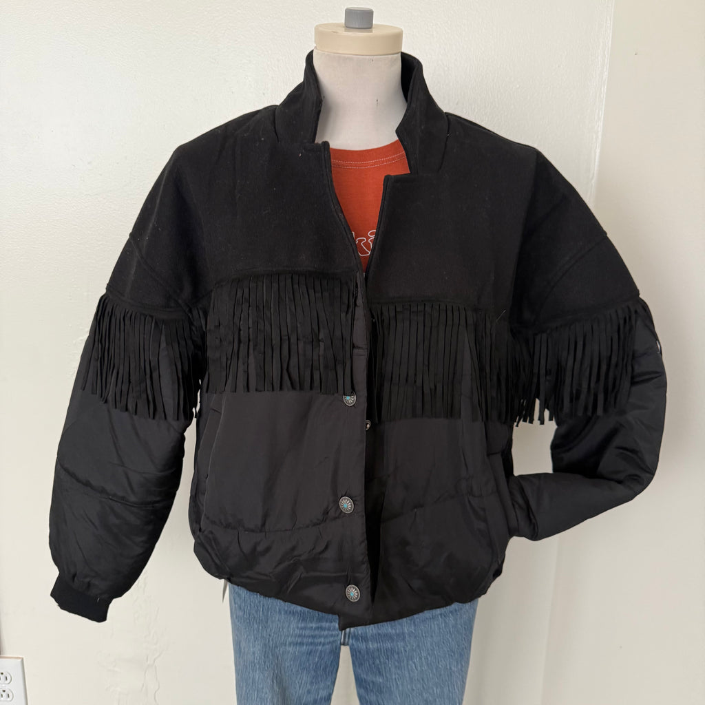 Black fringed jacket on a mannequin against a white background