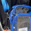 Clear blue bag with a visible brand label on a person wearing a black shirt.