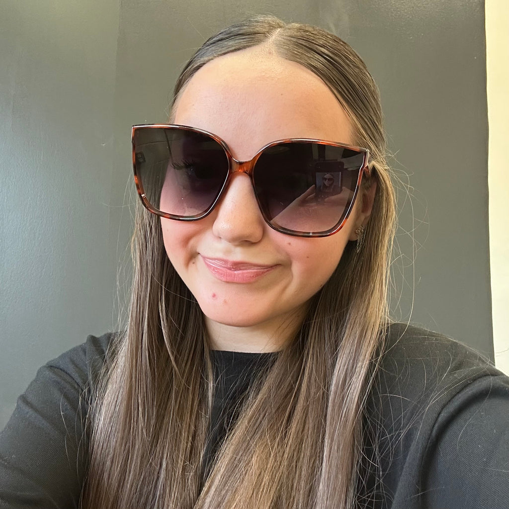 Person wearing large sunglasses with a 