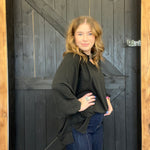 Woman standing in front of a wooden door
