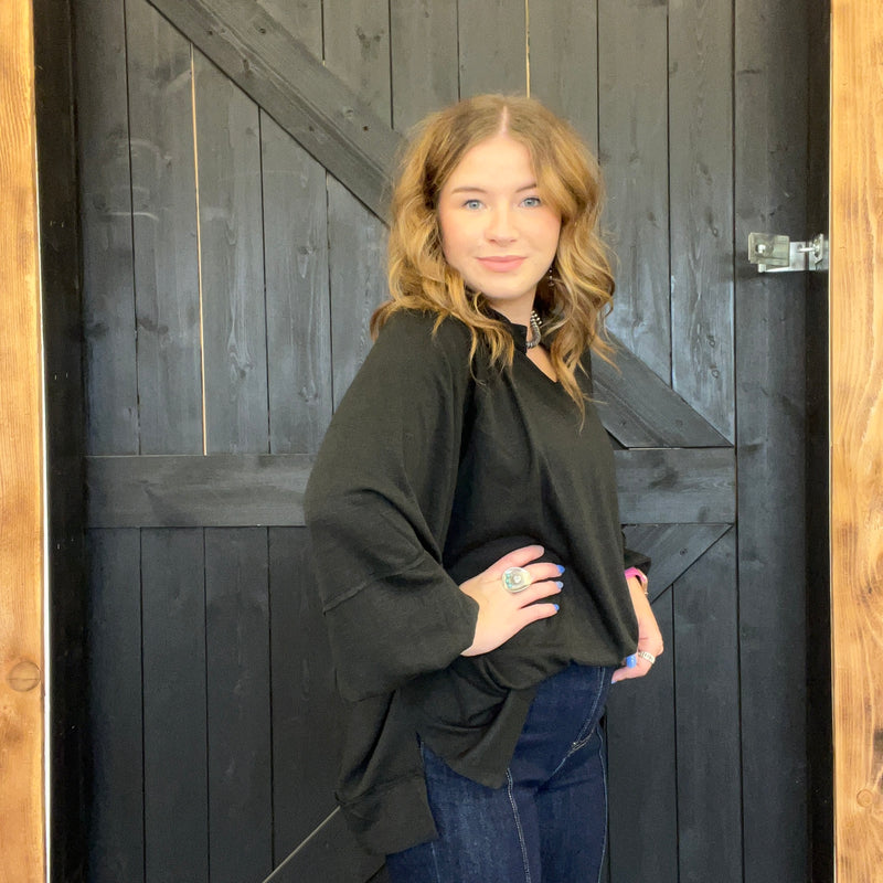 Woman standing in front of a wooden door