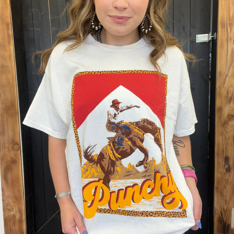 Person wearing a white t-shirt with a graphic design of a cowboy and the word 'Punchy'.