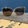 Sunglasses with gold frame and dark lenses