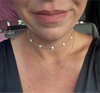 gold necklace with a bow pendant and a pearl necklace.