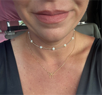 gold necklace with a bow pendant and a pearl necklace.