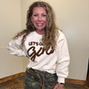 white sweatshirt with 'Let's Go Girl' text and camouflage pants