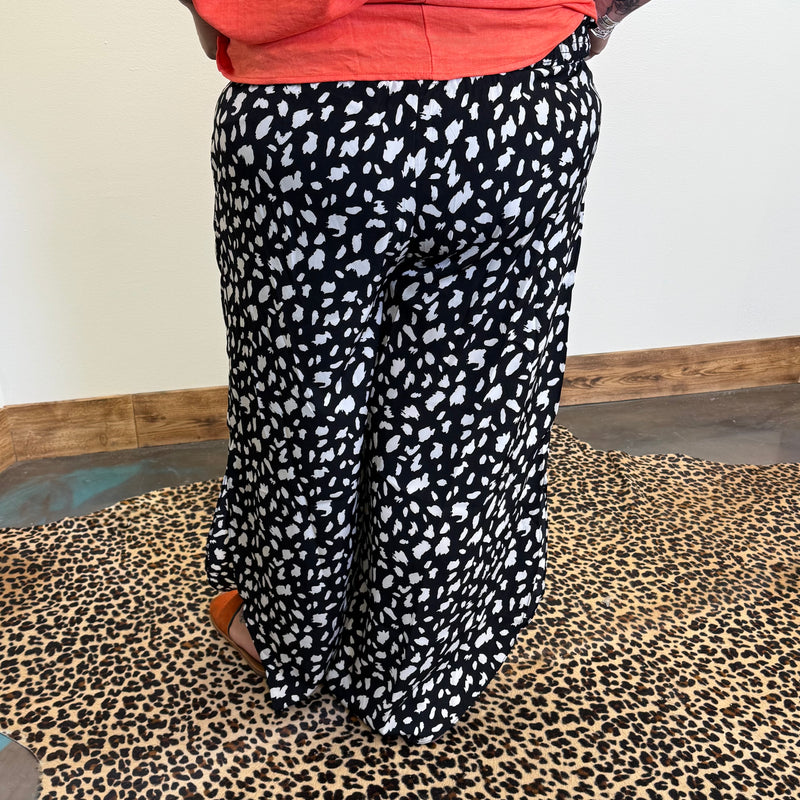 Person wearing black and white patterned pants 