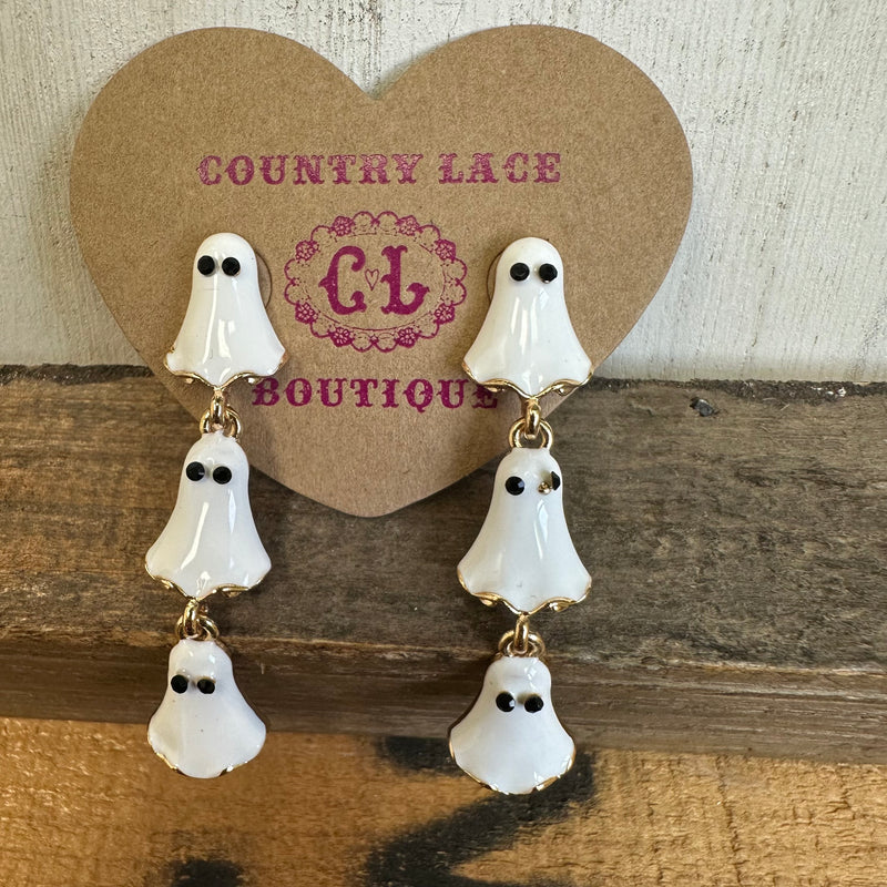 Ghost-shaped earrings on a Country Lace Boutique card against a wooden background