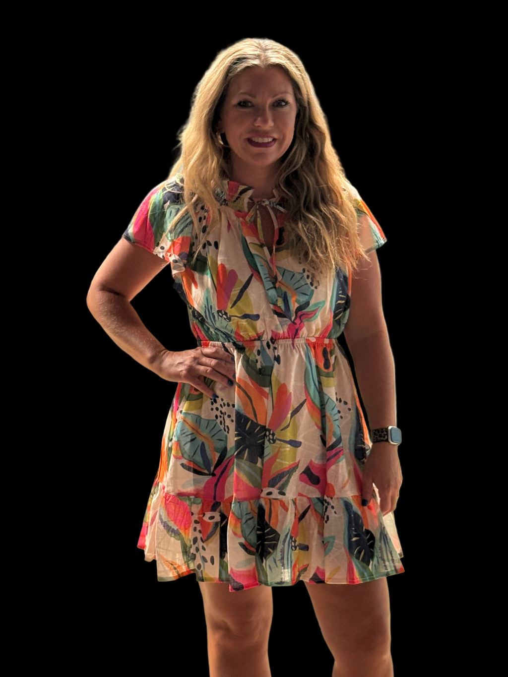 Woman wearing a colorful dress standing outdoors with a blurred background