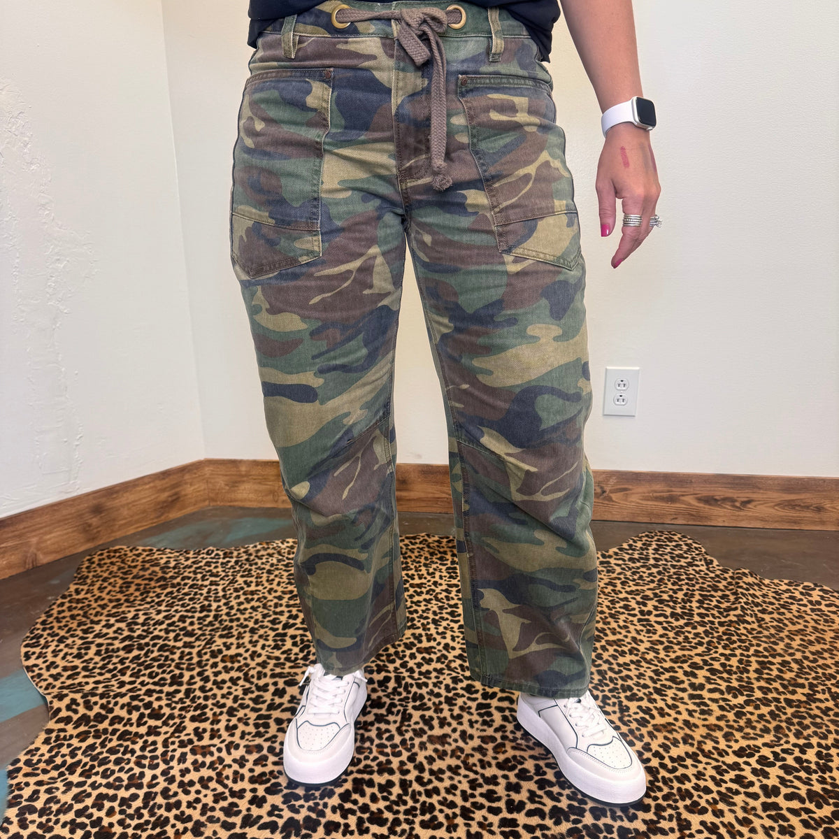 camouflage pants and white sneakers 