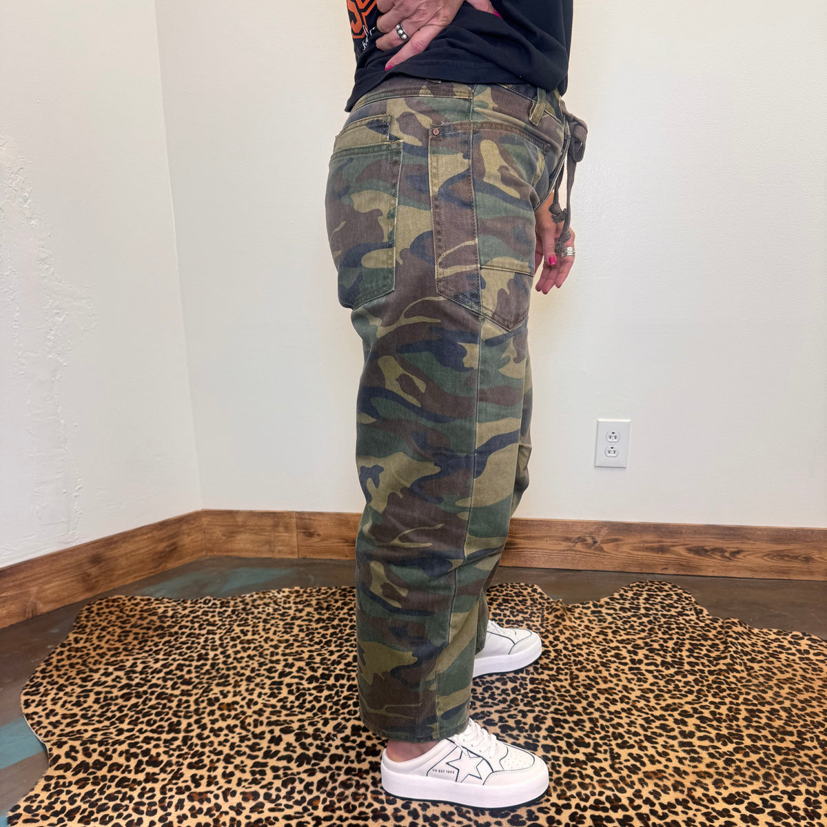 camouflage pants and white sneakers 
