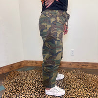camouflage pants and white sneakers 