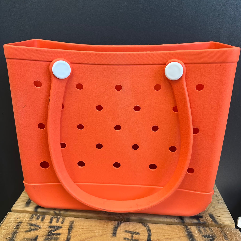Orange bucket with handles on a dark background