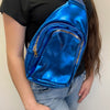 Person wearing a shiny blue backpack with gold zippers.