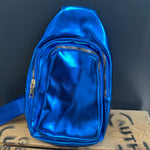 Blue metallic backpack on a wooden surface with a dark background