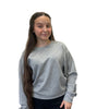 Person wearing a gray sweatshirt against a plain background