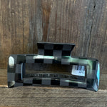Checkered patterned object with a barcode label on a wooden surface