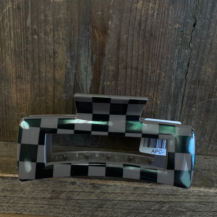 Checkered patterned object with 'APC' label on a wooden surface