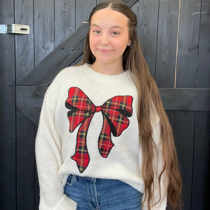 sweater with a large red plaid bow 