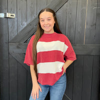 red and white striped sweater against a wooden background