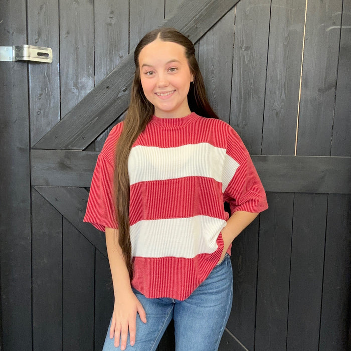 red and white striped sweater against a wooden background