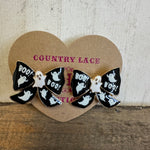 Bow-shaped hair clips with ghost and 'BOO!' designs on a heart-shaped 'Country Lace' card.