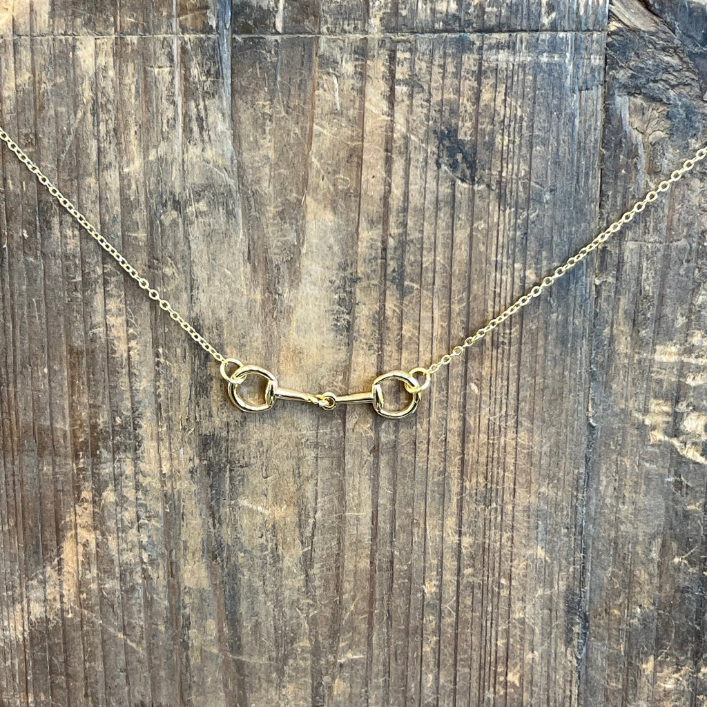 Gold necklace on a wooden surface