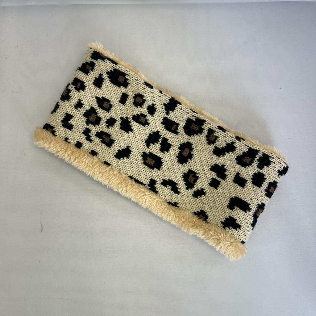 Leopard print pouch with beige trim on a light gray background